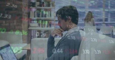 Animation of stock market data processing over thoughtful caucasian man using laptop at office. Global economy and business technology concept