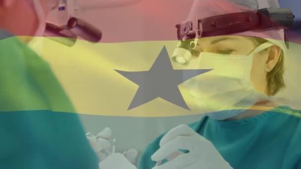 Animation Waving Ghana Flag Caucasian Female Surgeon Performing Surgery Hospital — Stock Video