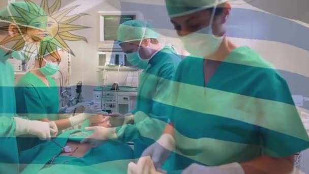 Animation Drapeau Uruguay Agitant Sur Équipe Divers Chirurgiens Effectuant Une — Video