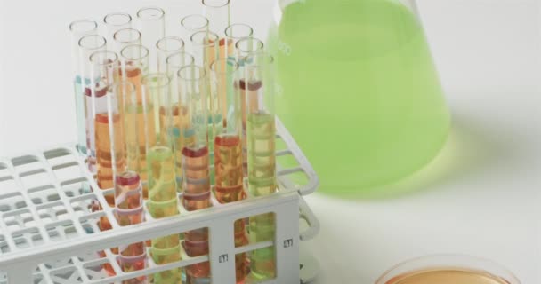彩色液体在瓶中 试管在白色背景上 慢动作 实验室 学校和教育概念 — 图库视频影像