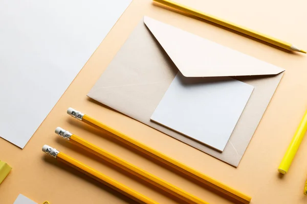 stock image Flat lay of yellow pencils, pen and white paper with copy space on yellow background. School materials, writing, colouring, drawing, learning, school and education concept.