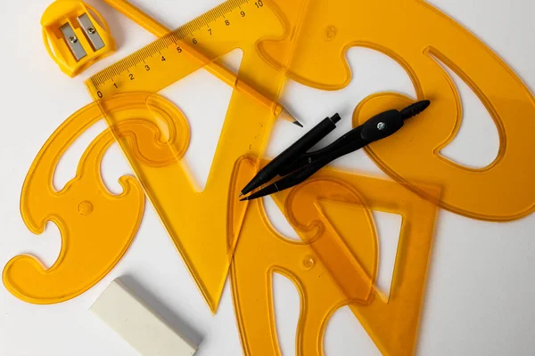 Close Yellow Rulers Compass Sharpener White Background School Materials Mathematics — Stock Photo, Image