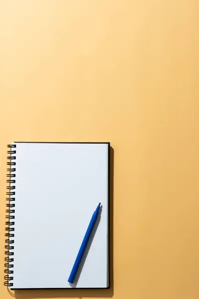 Feche Caderno Marcador Azul Com Espaço Cópia Fundo Laranja Materiais — Fotografia de Stock