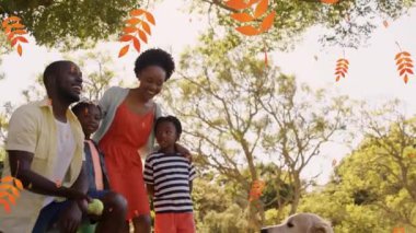 Afro-Amerikan ailesinin üzerine düşen sarı yaprakların animasyonu. Aile ve birlikte zaman geçirme kavramı dijital video üretimi.