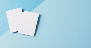 Mavi arka planda boş beyaz kartvizitler, kopyalama alanı, yavaş çekim. İş, iletişim detayları, modelleme, tasarım şablonu.