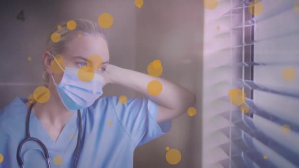 Animatie Van Gele Vlekken Boven Blanke Vrouwelijke Gezondheidswerker Die Uit — Stockvideo