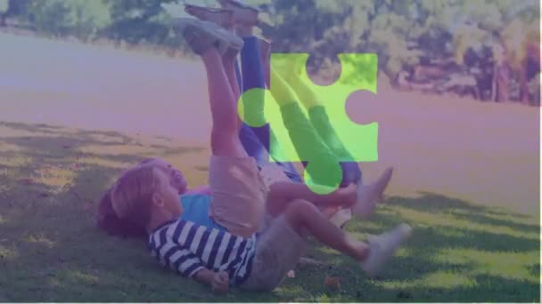 Animation Jigsaw Puzzle Diverse Children Lying Green Filed Raising Legs — Stock Video