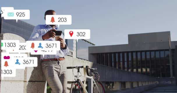 Анімація Іконок Соціальних Мереж Над Афроамериканським Чоловіком Який Використовує Смартфон — стокове відео