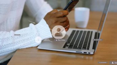 Ağ bağlantılarının ve sosyal medya ikonlarının animasyonu akıllı telefonlu Afro-Amerikan bir adam üzerinde. Dijital olarak oluşturulmuş küresel bağlantılar, hesaplama ve veri işleme kavramı.