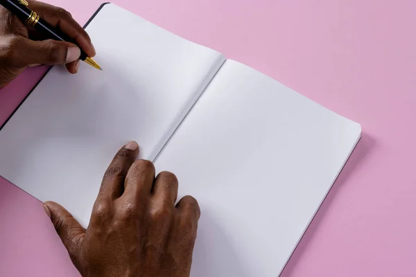 Hands Biracial Man Holding Pen Writing Notebook Copy Space Pink — Stock Photo, Image