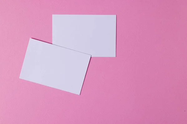 stock image White business cards with copy space on pink background. Business, business card, stationery and writing space concept.