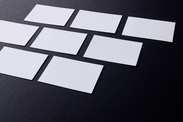 White business cards with copy space on black background. Business, business card, stationery and writing space concept.