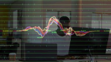 Animation of financial data processing over african american businessman in office. Global business, finances, computing and data processing concept digitally generated video.