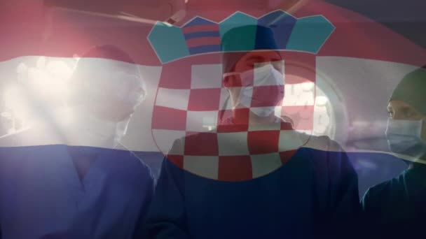 Animación Ondear Bandera Croacia Sobre Equipo Cirujanos Diversos Que Realizan — Vídeos de Stock