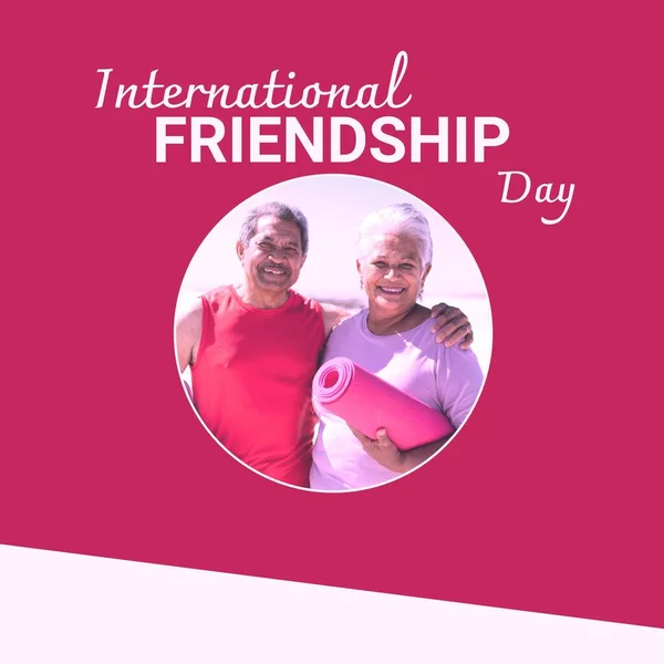 International Friendship Day Text Red Happy Senior Biracial Couple Embracing — Stock Photo, Image