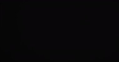 Video of blue sand grains thrown in air and copy space on black background. Sand, texture and pattern concept.