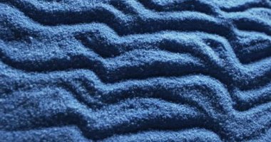 Video of close up of blue coloured sand with pattern and copy space background. Sand, texture and pattern concept.
