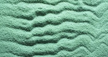 Kum yeşil renkli, desenli kumu yakın çekim videosu ve arka planı kopyalama. Kum, doku ve kalıp kavramı.