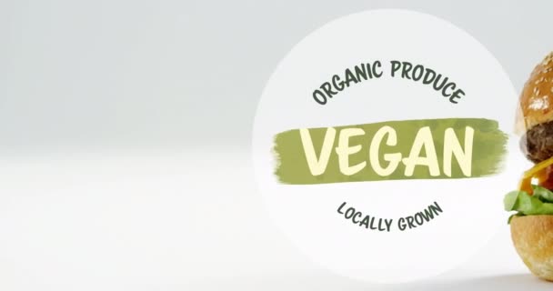 木製ボード上のビーガンバーガー上のビーガンフードテキストのアニメーション ビーガンフード 有機生鮮食品 持続可能性の概念デジタル生成されたビデオ — ストック動画