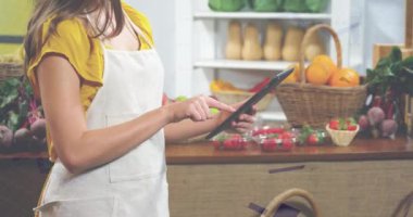 Animation of statistics data processing over caucasian woman working in food shop. Business, retail, communication, digital interface, finance and data processing concept digitally generated video.