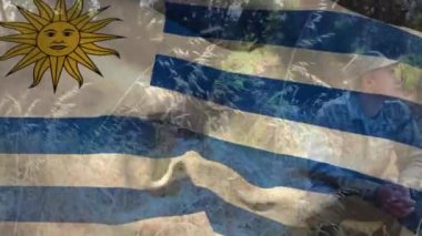 Çeşitli erkek askerler üzerinde uruguay bayrağının animasyonu. Vatanseverlik, silahlı kuvvetler ve dijital olarak üretilen ulusal savunma konsepti.