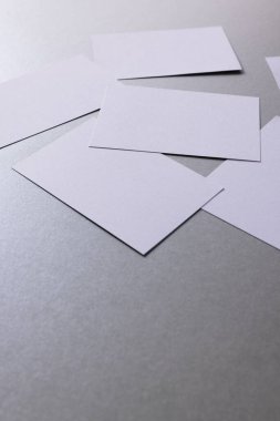 White business cards with copy space on grey background. Business, business card, stationery and writing space digitally generated image.