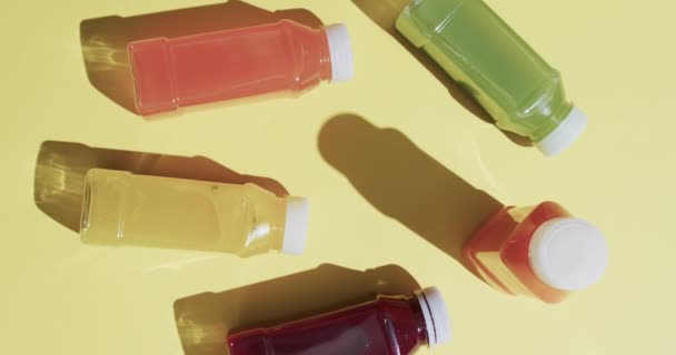 Video Bottles Fruit Juices Copy Space Yellow Background Fresh Food — Stock Video