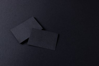 Black business cards with copy space on black background. Business, business card, stationery and writing space digitally generated image.