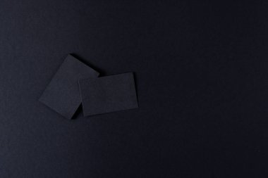 Black business cards with copy space on black background. Business, business card, stationery and writing space digitally generated image.