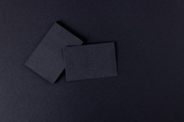 Black business cards with copy space on black background. Business, business card, stationery and writing space digitally generated image.