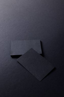 Black business cards with copy space on black background. Business, business card, stationery and writing space digitally generated image.
