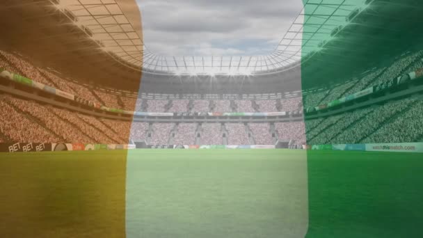 Animatie Van Ivoren Kustvlag Tegen Het Zicht Van Een Sportstadion — Stockvideo