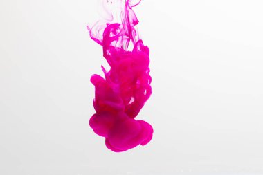 Sudaki pembe mürekkebi kapatın ve beyaz arkaplanda kopya alanı olsun. Mürekkep, sıvı, şekil ve renk kavramı.