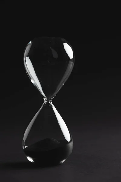 ブラックサンドで時計ガラスを閉じ 黒い背景にスペースをコピーします タイムキーピング カラーコンセプト — ストック写真