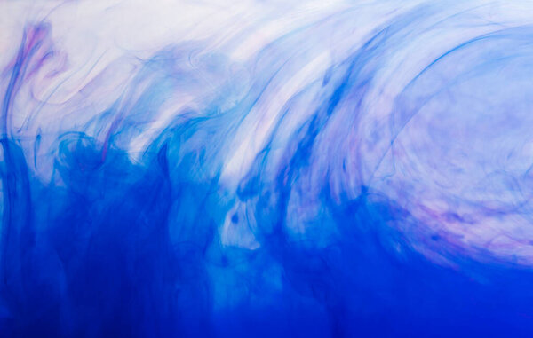 Close up of blue ink in water with copy space on white background. Ink, liquid, shape and colour concept.