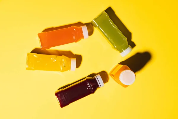Close Plastic Bottles Fresh Juice Copy Space Yellow Background Fruit — Stock Photo, Image