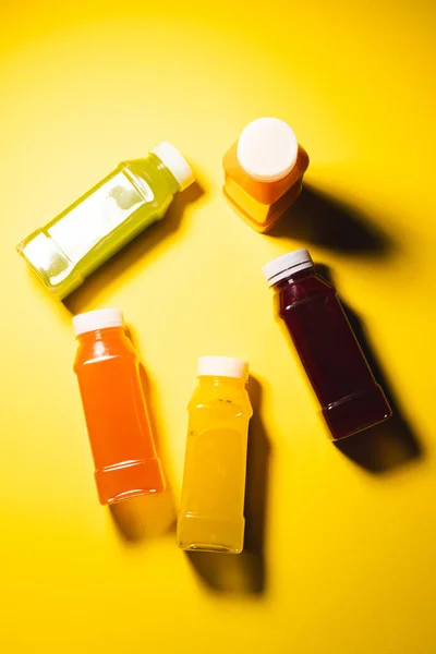 Close Plastic Bottles Fresh Juice Copy Space Yellow Background Fruit — Stock Photo, Image