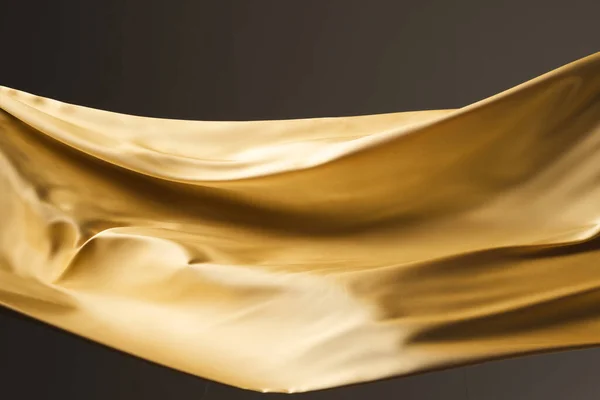 Nahaufnahme Aus Goldglänzendem Seidenstoff Mit Kopierraum Auf Schwarzem Hintergrund Textur — Stockfoto