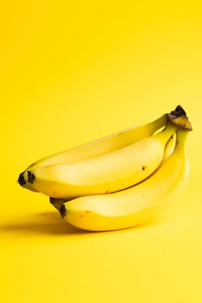 stock image Close up of bananas and copy space on yellow background. Fruit, exotic fruit, food, freshness and colour concept.