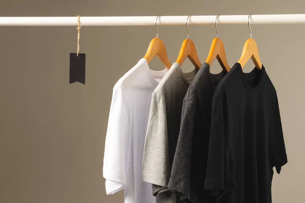 Four Shirts Hangers Hanging Clothes Rail Copy Space Grey Background — Stock Photo, Image