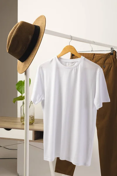 Λευκό Πουκάμισο Καπέλο Και Καφέ Παντελόνι Κρέμονται Από Ράγα Ρούχα — Φωτογραφία Αρχείου