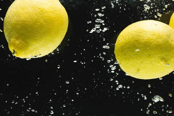 Close Lemons Falling Water Copy Space Black Background Fruit Food — Stock Photo, Image