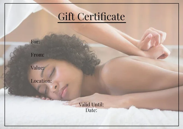 Gift certificate text with blank space for details in black over biracial woman having massage. Beauty spa, massage gift voucher certificate template concept digitally generated image.