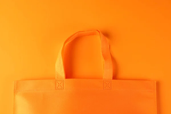 オレンジ色の背景のコピースペースでオレンジ色のキャンバスバッグを閉じます ショッピング バッグ カラー ファブリック テクスチャ 素材コンセプト — ストック写真