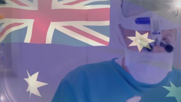 Animation Australian Flag Caucasian Doctor Using Magnifying Glass Performing Surgery — Stock Video