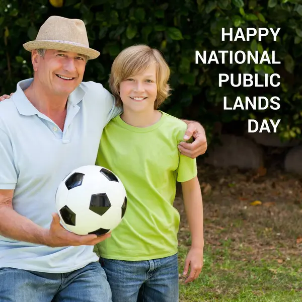 Composite of happy national public lands day text over caucasian father and son with ball in park. National public lands day, nature and landscape concept digitally generated image.