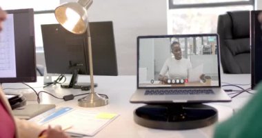 Ekranda Afro-Amerikan iş kadınıyla video bağlantısı olan bir laptop. Çevrimiçi bağlantılar, iş ve ağ oluşturma kavramı.