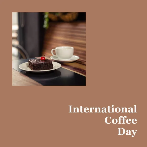 International coffee day text on brown with slice of cake and cup of coffee on table. Coffee drinking appreciation and promotional campaign concept digitally generated image.