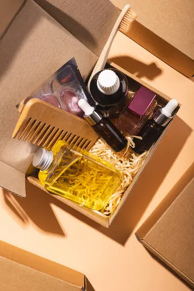 Vertical image of box with beauty products, rows of boxes and copy space over cream background. Cyber monday, black friday, online shopping, shipping and global connections concept.