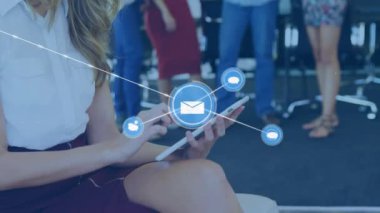 Animation of network of digital icons against caucasian woman using digital tablet at office. Global networking and business technology concept